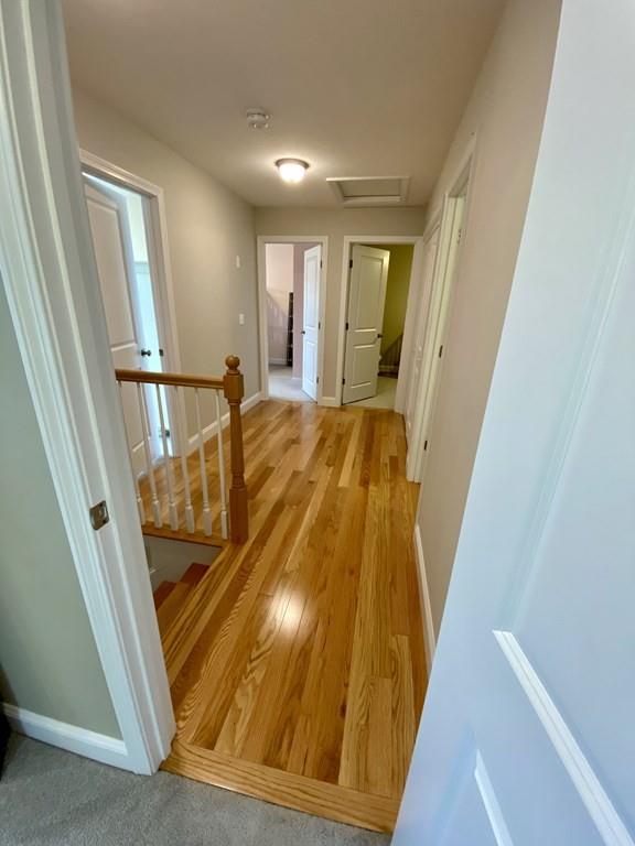 84 Old Pasture Road Dracut, MA 01826 - Photo 13 of 37 a view of a hallway with wooden floor and staircase