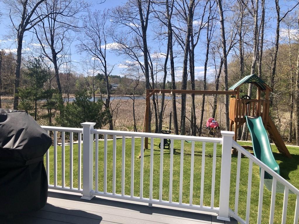 84 Old Pasture Road Dracut, MA 01826 - Photo 32 of 37 a view of a house with backyard and deck