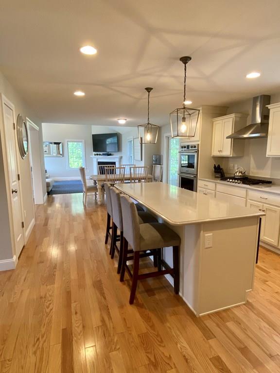 84 Old Pasture Road Dracut, MA 01826 - Photo 5 of 37 a large kitchen with a table and chairs