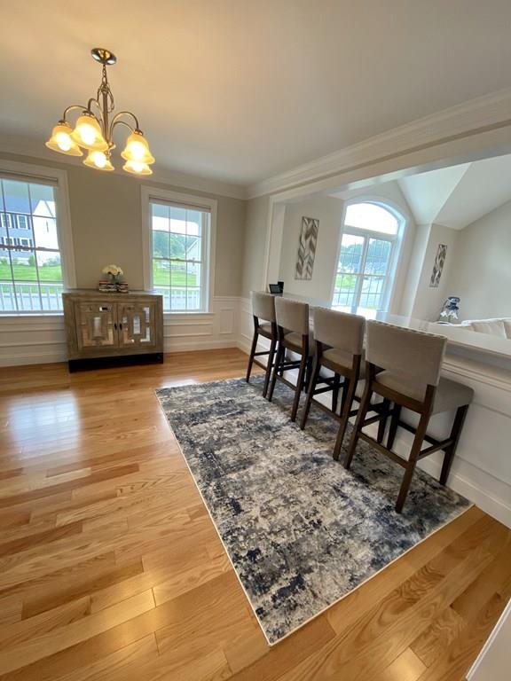 84 Old Pasture Road Dracut, MA 01826 - Photo 8 of 37 a view of a dining room with furniture and wooden floor