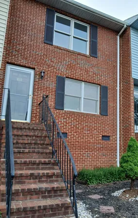 a brick building with a black and white door
