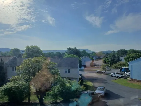 a view of a house with a backyard and furniture