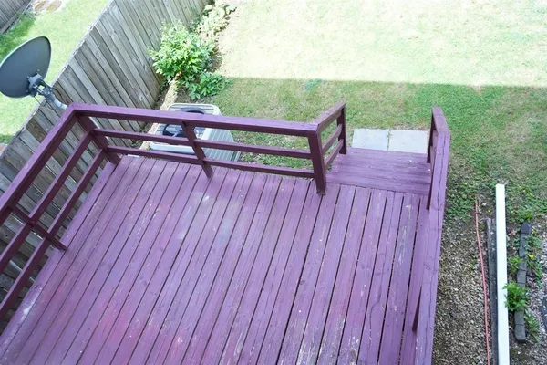 a view of a deck with two chair and wooden fence