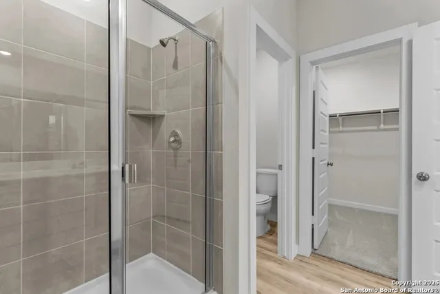 a bathroom with a shower and a glass door