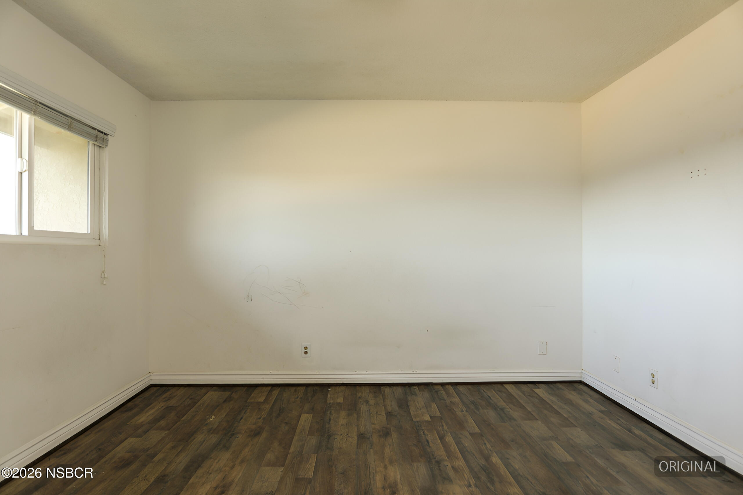 1321 North Bradley Road, Unit 14 Santa Maria, CA 93454 - Photo 15 of 30 a view of an empty room with wooden floor and a window