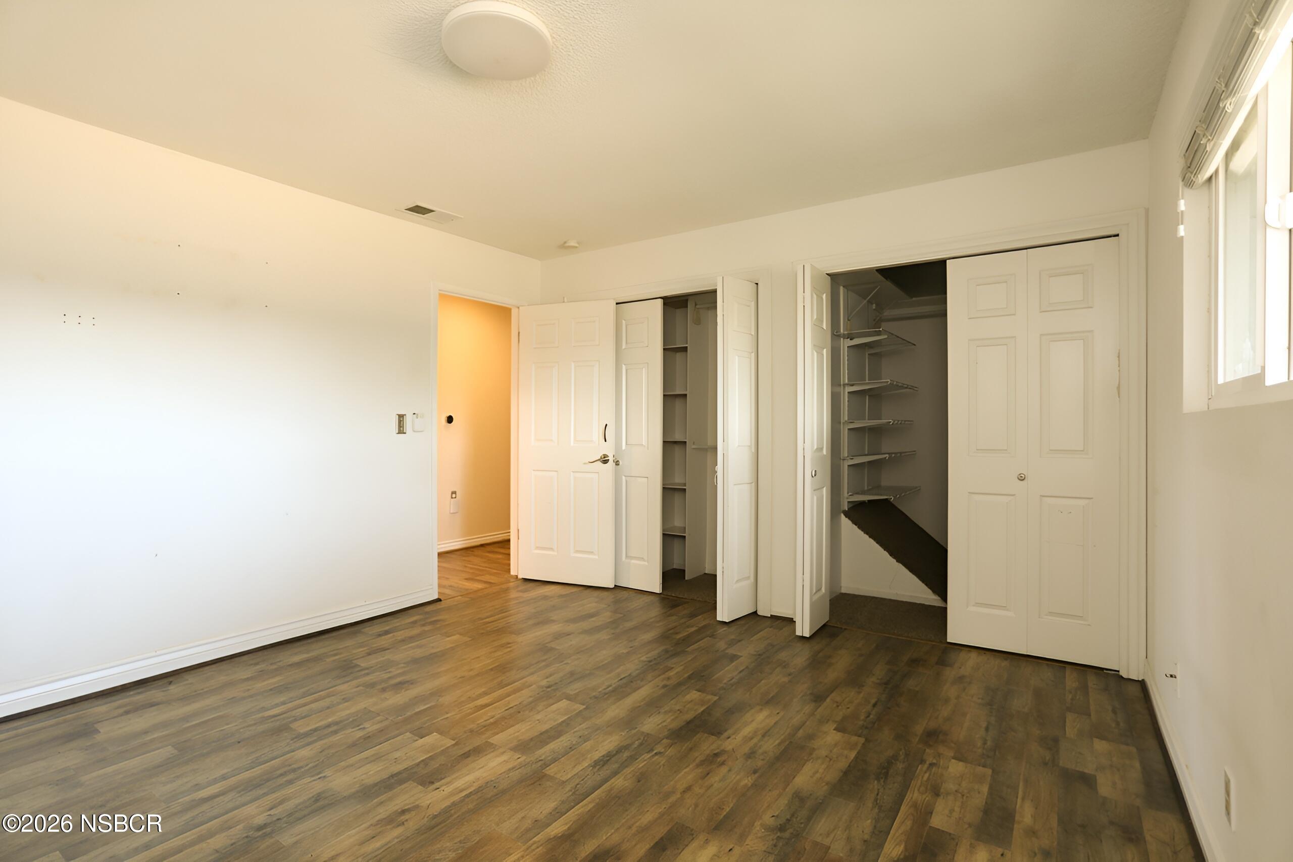 1321 North Bradley Road, Unit 14 Santa Maria, CA 93454 - Photo 16 of 30 an empty room with wooden floor and windows