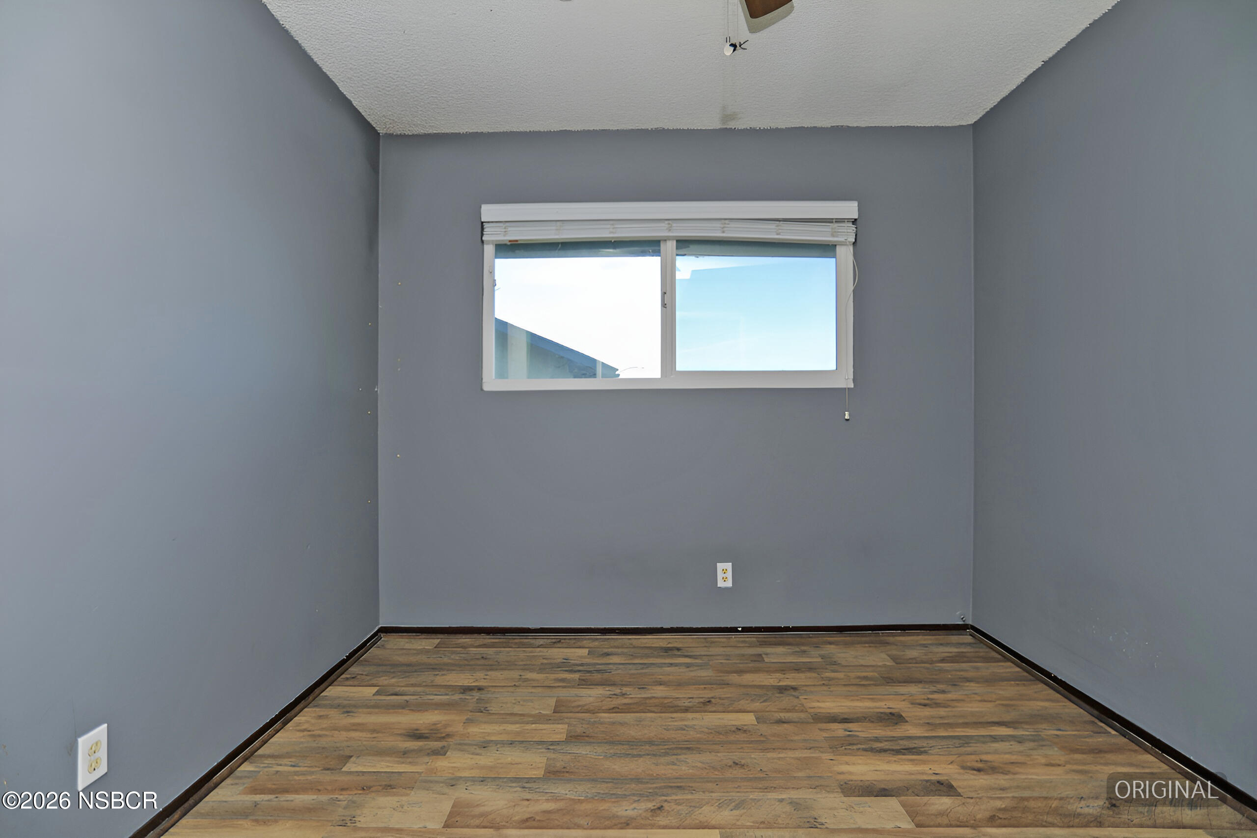 1321 North Bradley Road, Unit 14 Santa Maria, CA 93454 - Photo 20 of 30 a view of an empty room with wooden floor and a window
