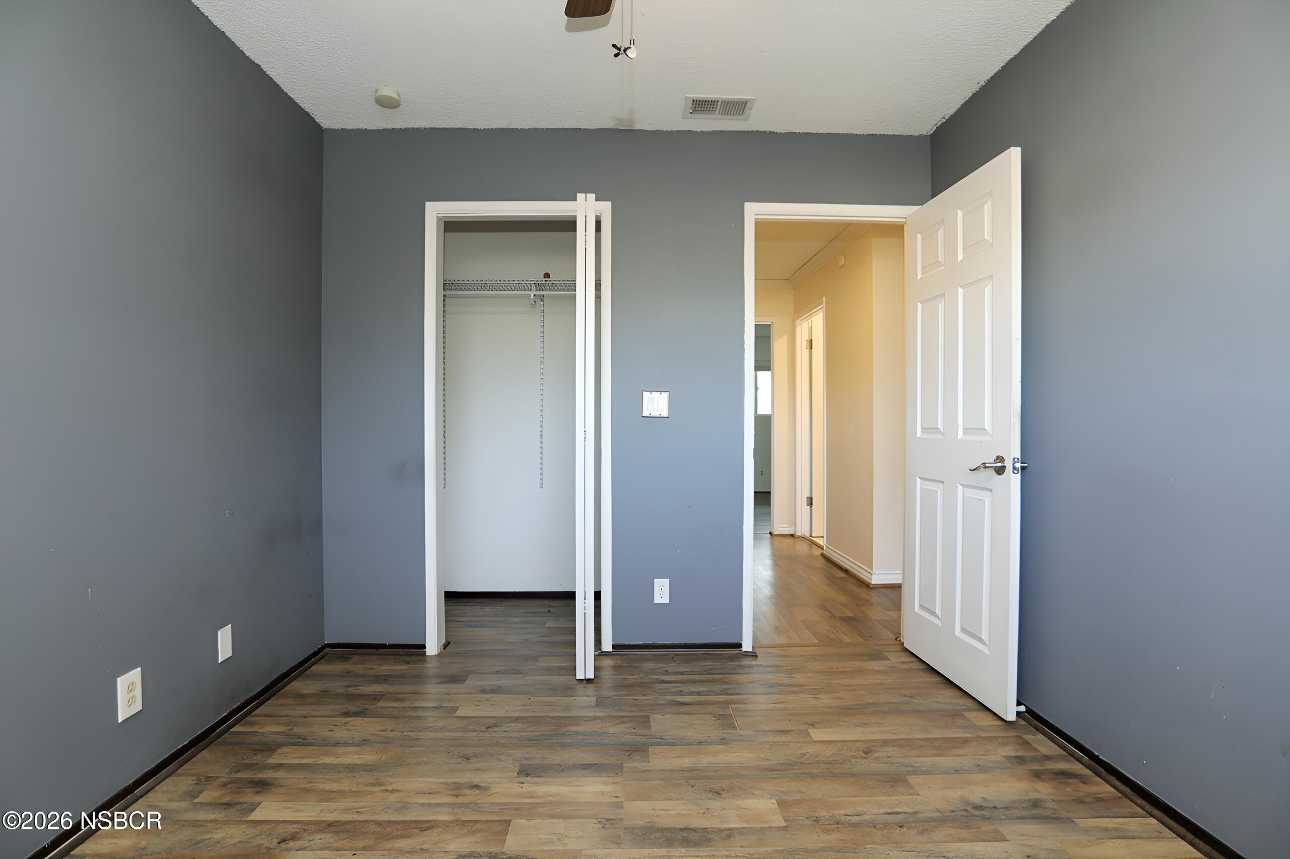 1321 North Bradley Road, Unit 14 Santa Maria, CA 93454 - Photo 21 of 30 a view of an empty room with wooden floor and a bathroom