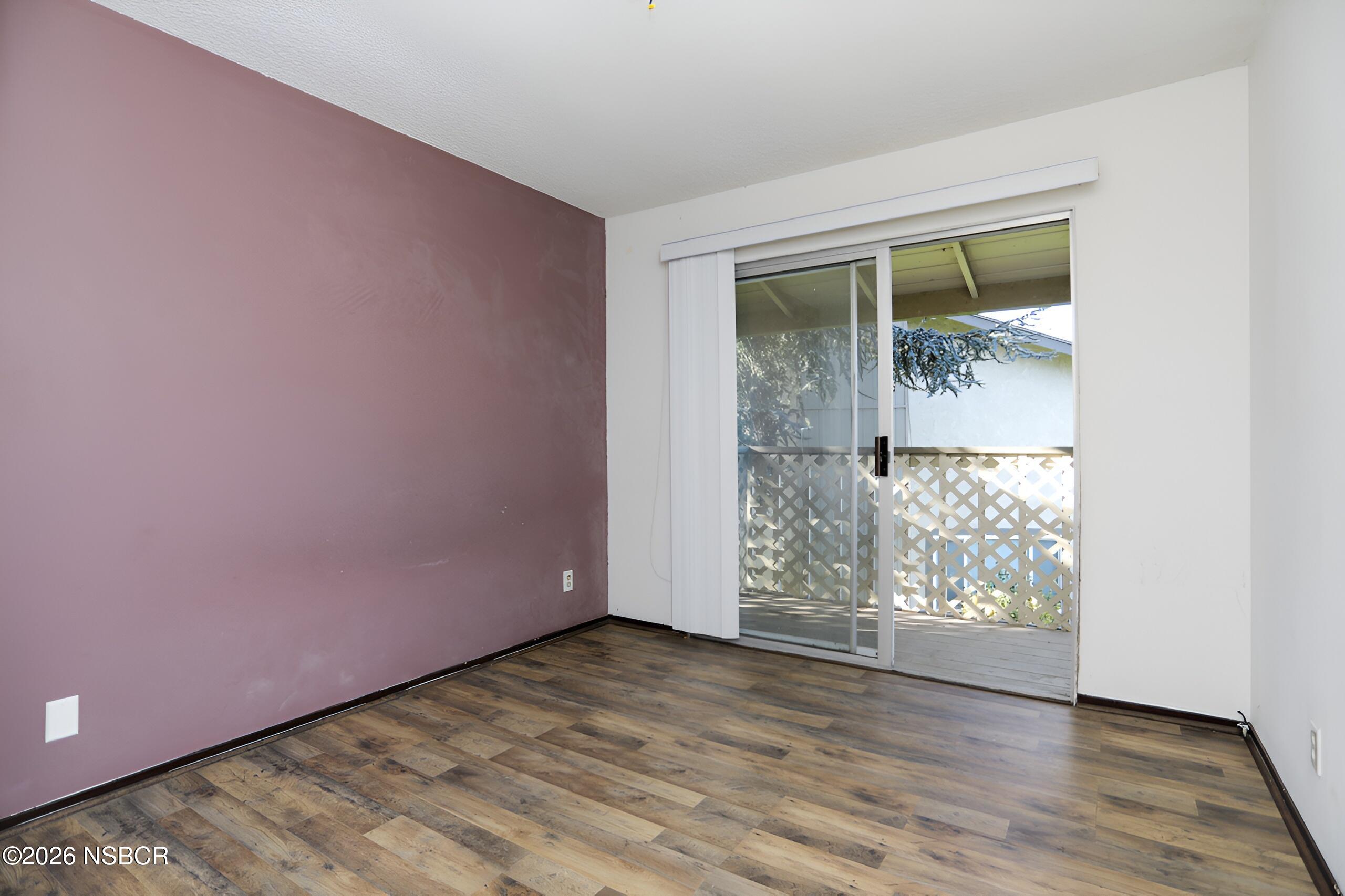 1321 North Bradley Road, Unit 14 Santa Maria, CA 93454 - Photo 22 of 30 an empty room with wooden floor and windows