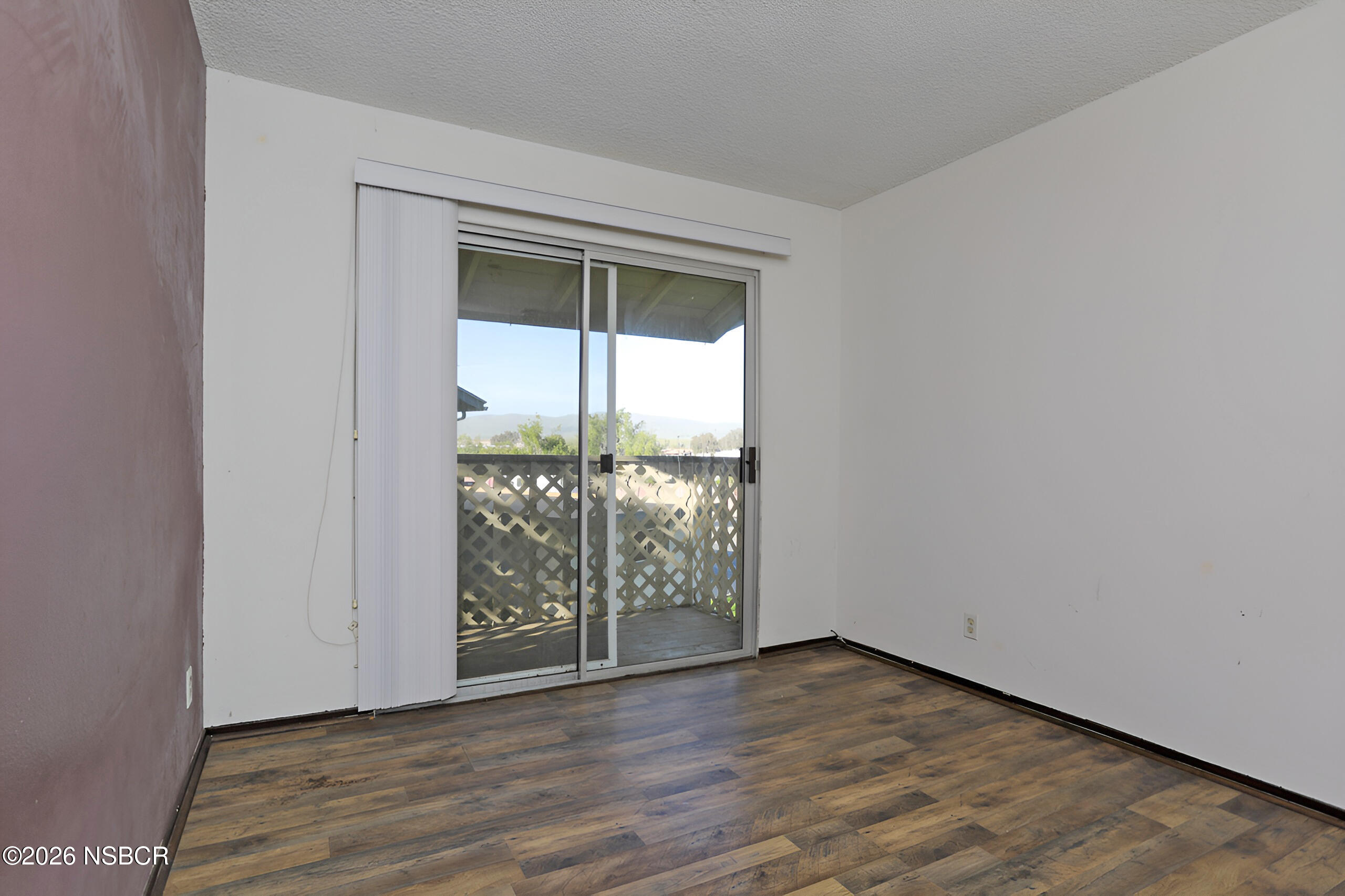 1321 North Bradley Road, Unit 14 Santa Maria, CA 93454 - Photo 23 of 30 an empty room with wooden floor and windows