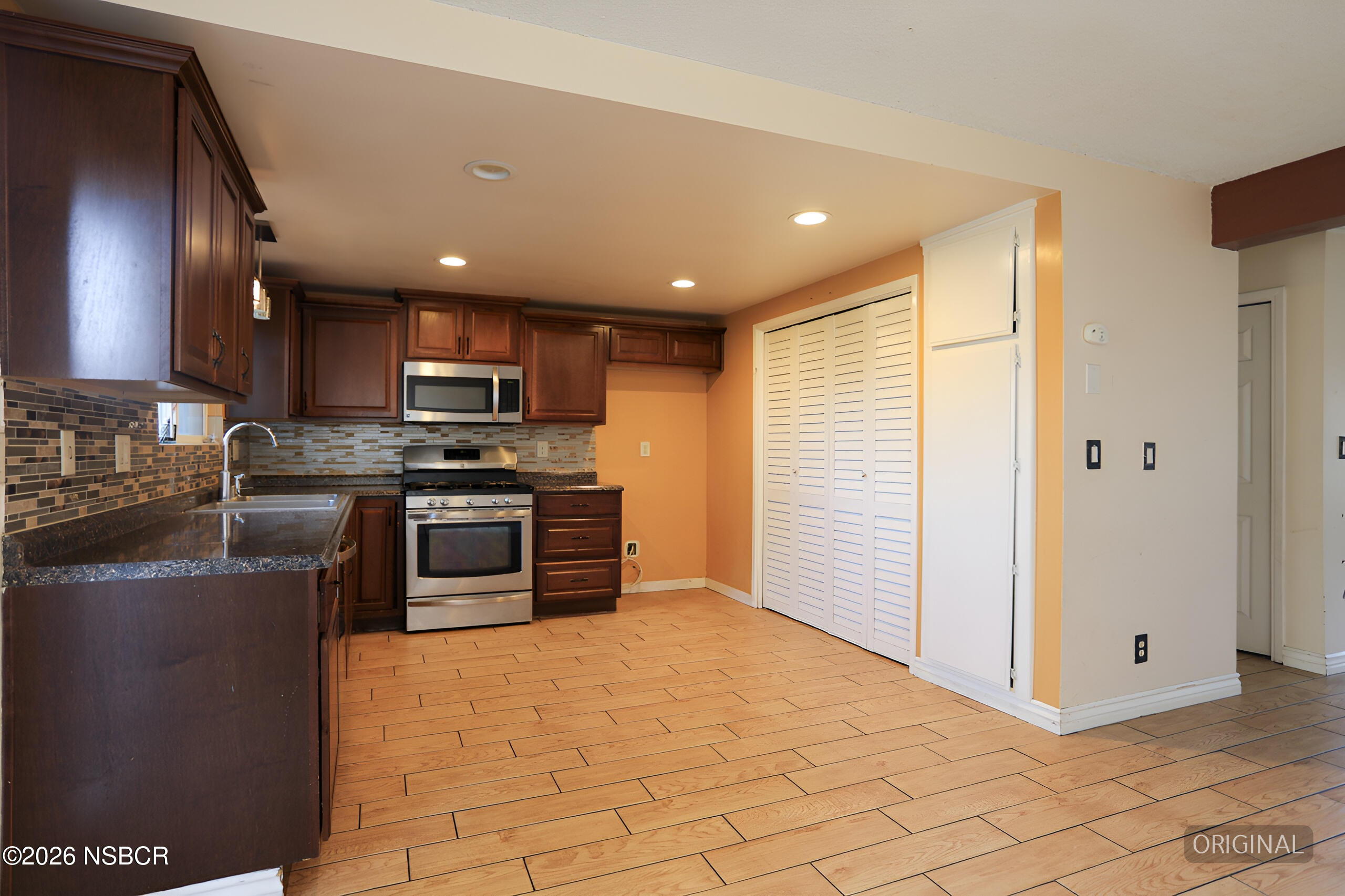 1321 North Bradley Road, Unit 14 Santa Maria, CA 93454 - Photo 8 of 30 a kitchen with stainless steel appliances granite countertop a refrigerator a stove a sink and a microwave