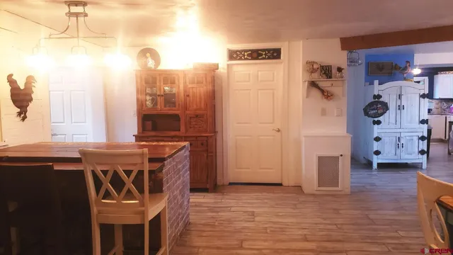 a view of a kitchen with refrigerator and window