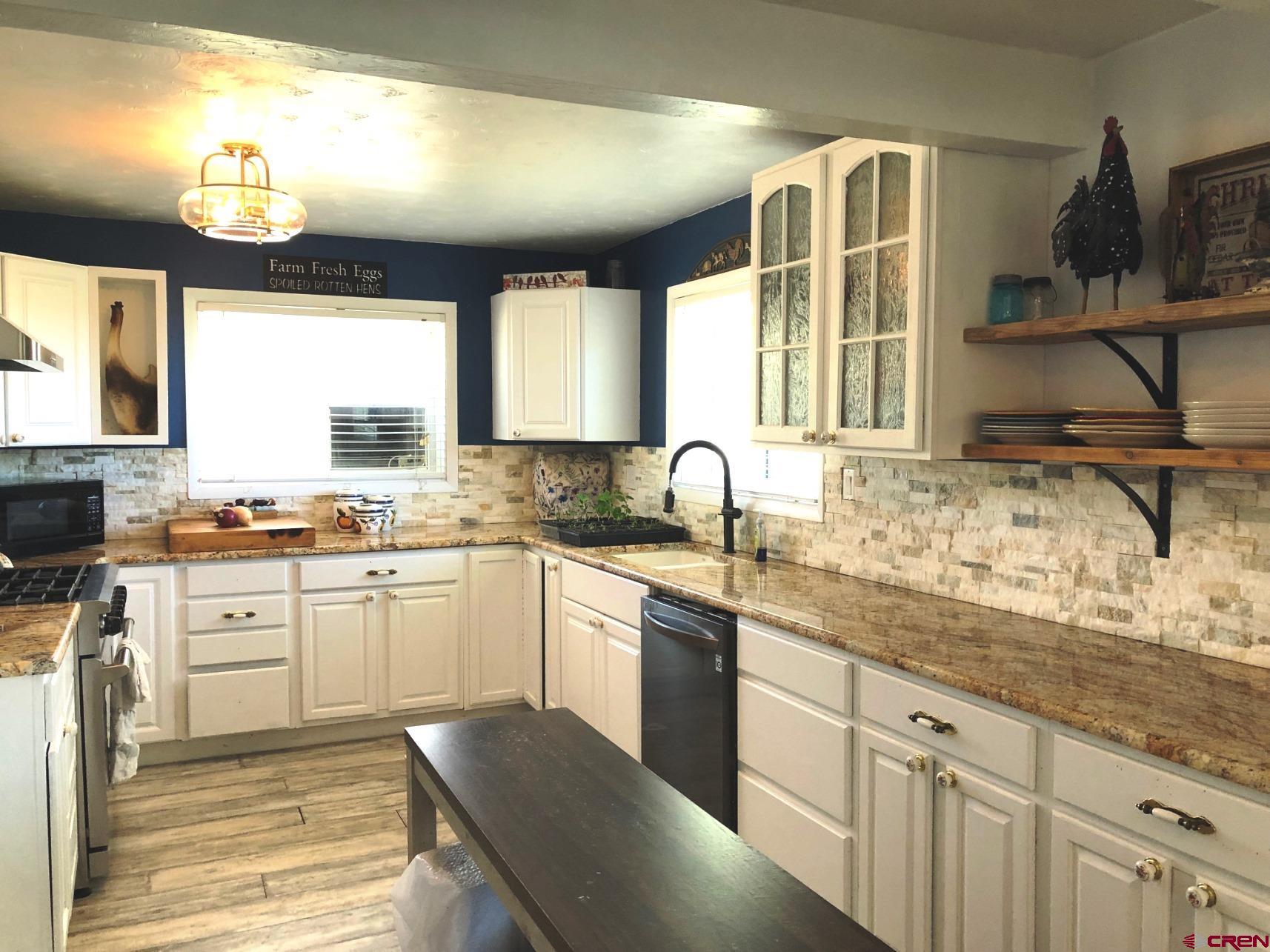 28236 Road H Cortez, CO 81321 - Photo 14 of 37 a kitchen with stainless steel appliances granite countertop a sink and a stove