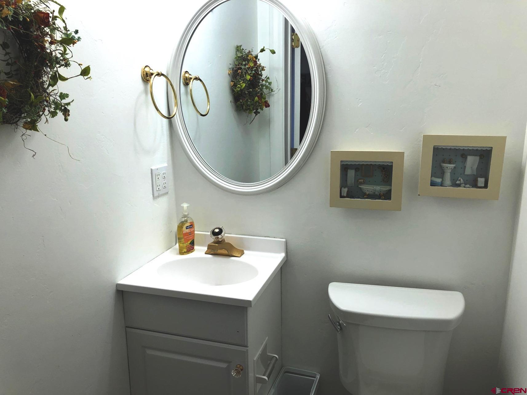 28236 Road H Cortez, CO 81321 - Photo 3 of 37 a bathroom with a toilet sink and mirror