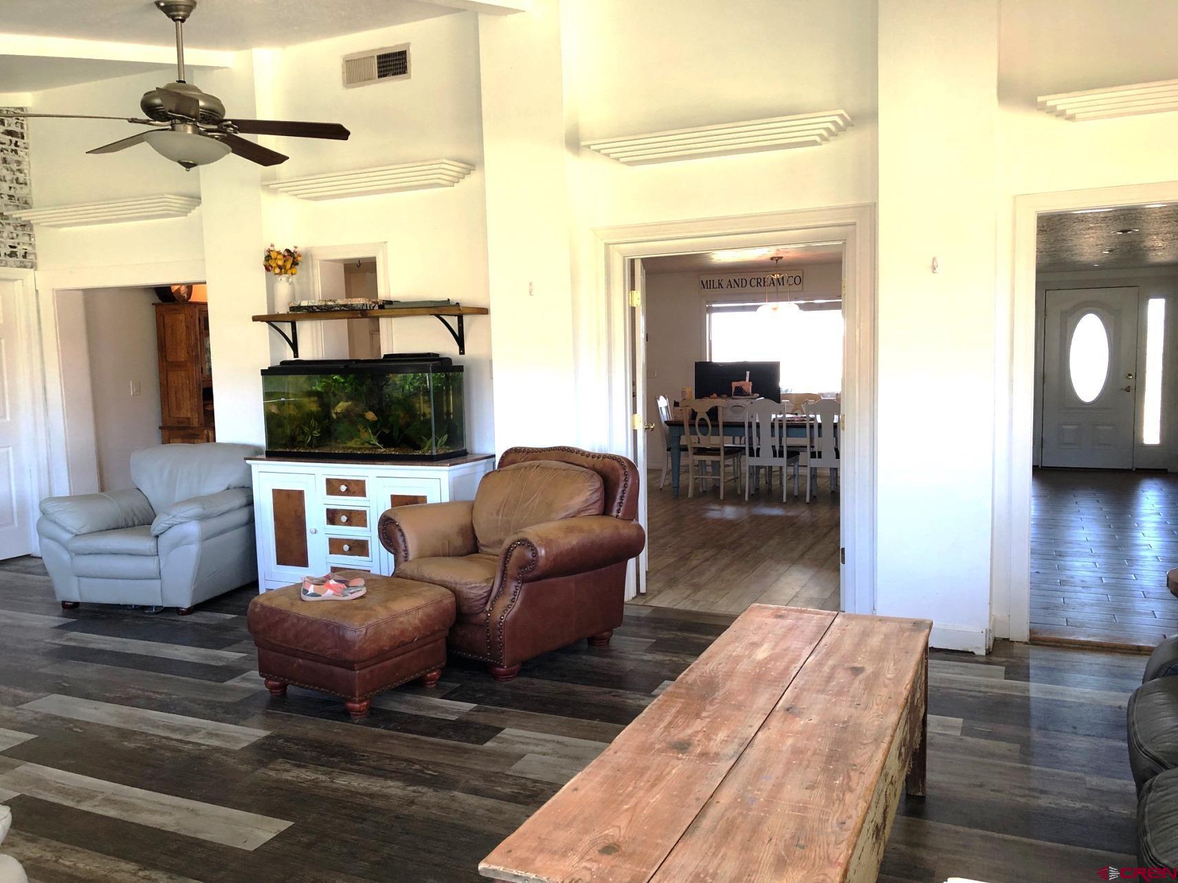 28236 Road H Cortez, CO 81321 - Photo 33 of 37 a living room with furniture a flat screen tv and kitchen view