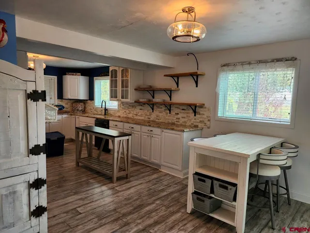a kitchen with a table chairs stove and cabinets