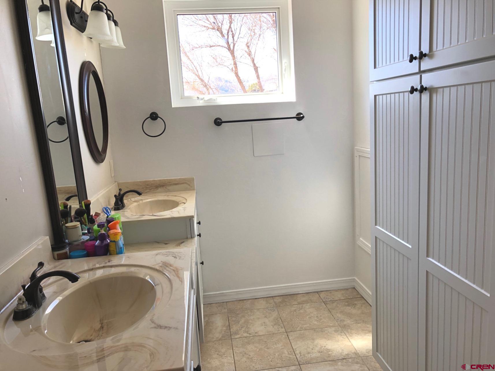 28236 Road H Cortez, CO 81321 - Photo 6 of 37 a bathroom with a sink mirror and toilet