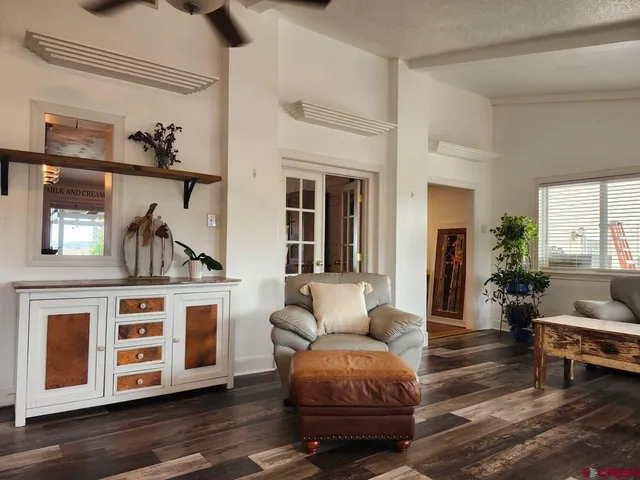 a living room with furniture and wooden floor