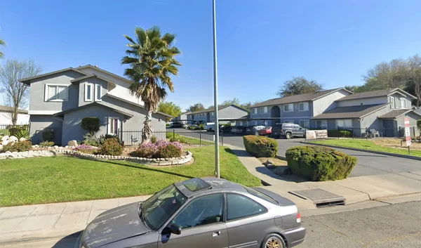 a front view of a house with swimming pool having outdoor seating