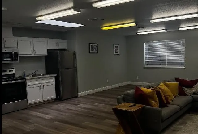 a kitchen with a refrigerator and a stove top oven
