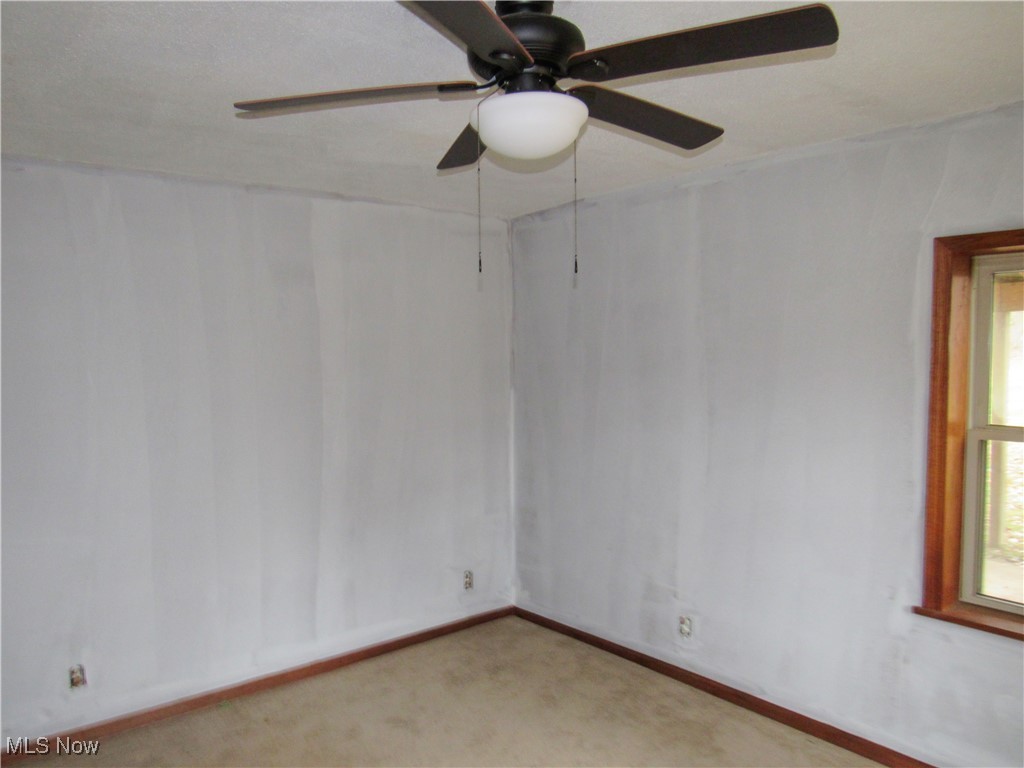 2218 Lake Road Akron, OH 44312 - Photo 7 of 20 Unfurnished room featuring baseboards and light colored carpet