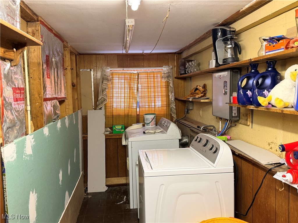 6101 Green Road Ashtabula, OH 44004 - Photo 13 of 16 Laundry area with washing machine and dryer and wooden walls