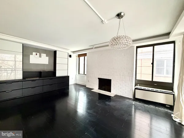 a living room with hardwood floor and a ceiling fan