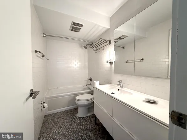 a bathroom with a toilet a sink and bathtub