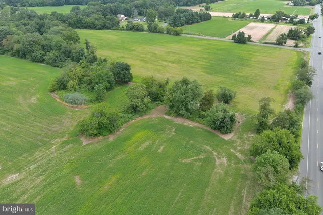 a picture of a room with a white wall and a picture of the view of a house