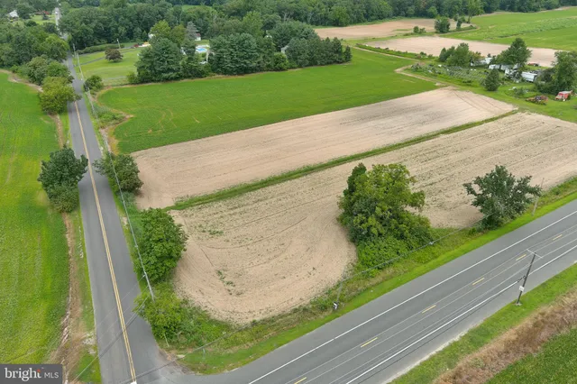 a view of a field with an ocean view