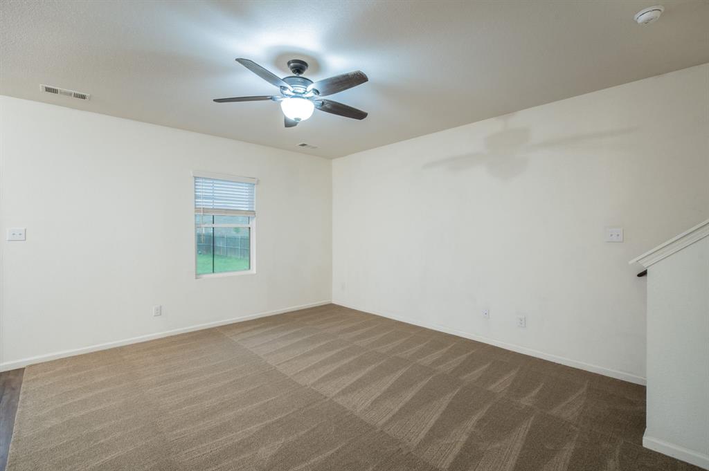 201 Sabine River Road Glenn Heights, TX 75154 - Photo 13 of 24 Spacious room featuring neutral carpeting, a ceiling fan with integrated lighting, and a window with blinds
