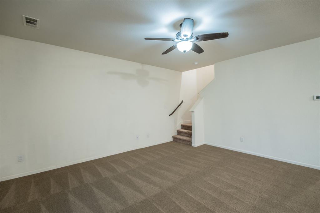 201 Sabine River Road Glenn Heights, TX 75154 - Photo 14 of 24 Spacious room featuring neutral carpet, light-toned walls, and a ceiling fan with integrated lighting