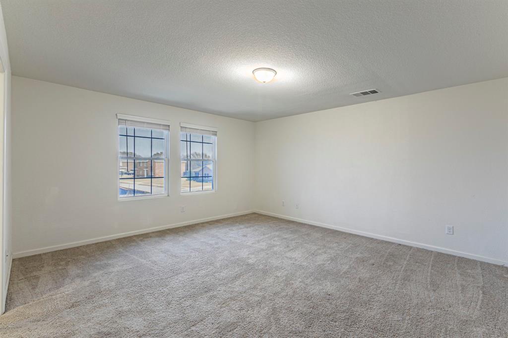 201 Sabine River Road Glenn Heights, TX 75154 - Photo 15 of 26 Spare room featuring a textured ceiling and light colored carpet