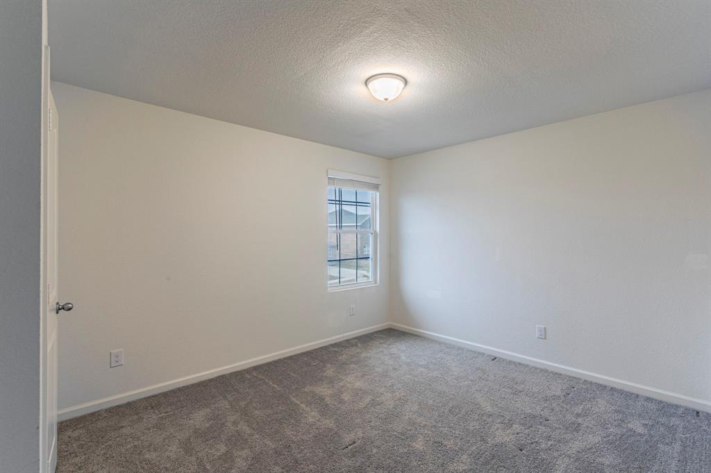 201 Sabine River Road Glenn Heights, TX 75154 - Photo 19 of 24 an empty room with windows