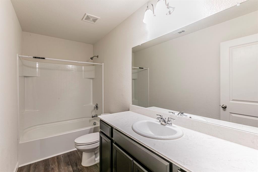 201 Sabine River Road Glenn Heights, TX 75154 - Photo 20 of 24 a bathroom with a granite countertop sink toilet and shower