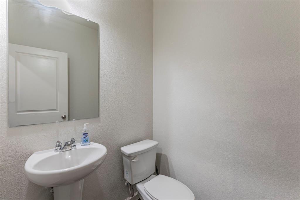 201 Sabine River Road Glenn Heights, TX 75154 - Photo 23 of 24 a bathroom with a sink a toilet and mirror