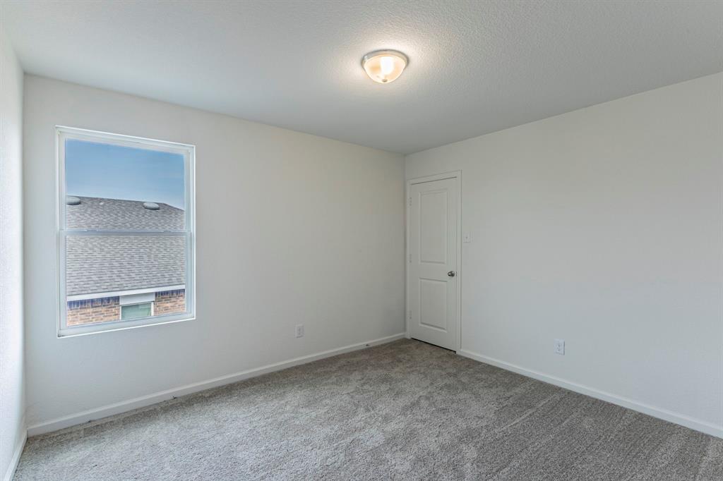 201 Sabine River Road Glenn Heights, TX 75154 - Photo 23 of 26 Unfurnished room with carpet and a textured ceiling