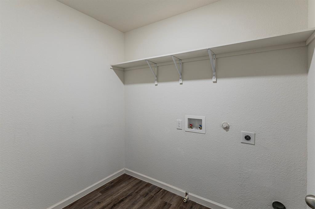 201 Sabine River Road Glenn Heights, TX 75154 - Photo 25 of 26 Laundry room featuring gas dryer hookup, dark wood finished floors, hookup for a washing machine, and a textured wall