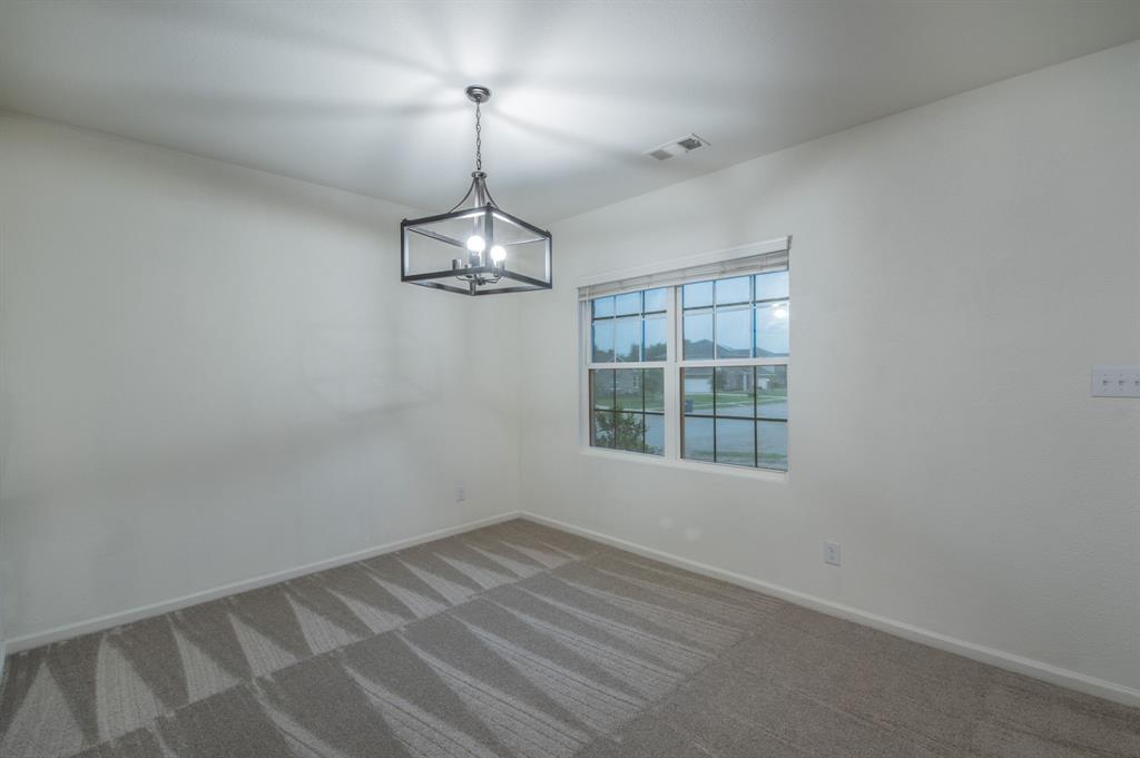 201 Sabine River Road Glenn Heights, TX 75154 - Photo 7 of 24 Flex room. Neutral wall paint, patterned carpeting, and a window with blinds.