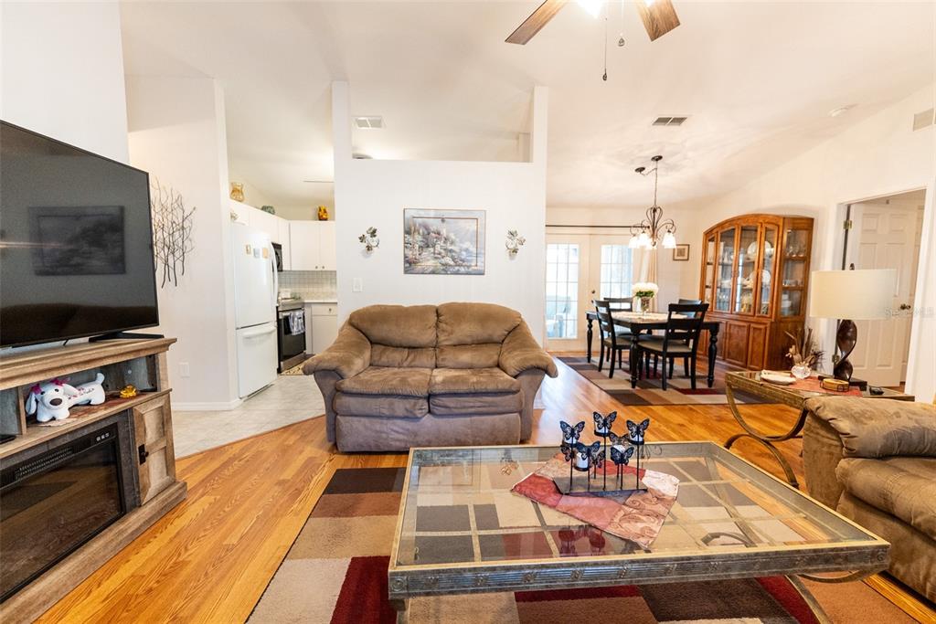 10470 Southwest 61st Terrace Road Ocala, FL 34476 - Photo 17 of 63 a living room with furniture and a flat screen tv