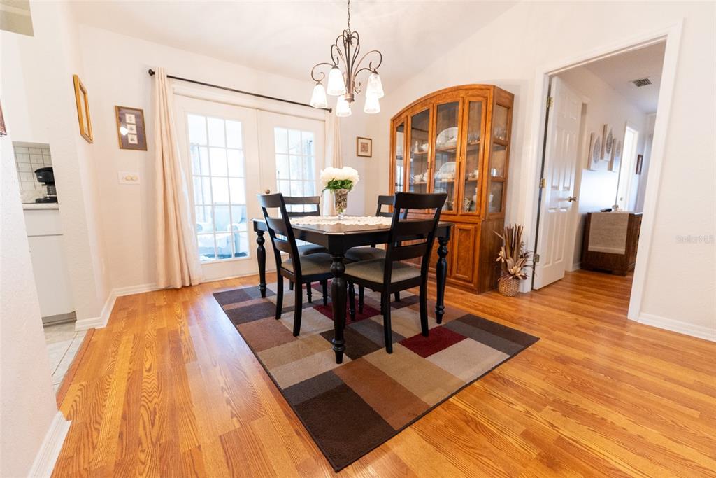 10470 Southwest 61st Terrace Road Ocala, FL 34476 - Photo 18 of 63 a view of a dining room with furniture and wooden floor