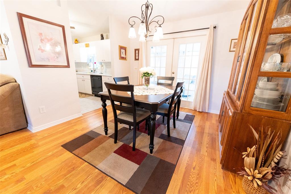 10470 Southwest 61st Terrace Road Ocala, FL 34476 - Photo 20 of 63 a view of a dining room with furniture and wooden floor