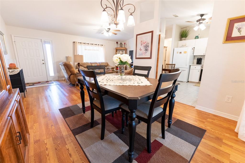 10470 Southwest 61st Terrace Road Ocala, FL 34476 - Photo 21 of 63 a view of a dining room with furniture and wooden floor
