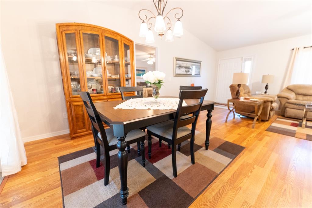 10470 Southwest 61st Terrace Road Ocala, FL 34476 - Photo 22 of 63 a view of a dining room with furniture and wooden floor