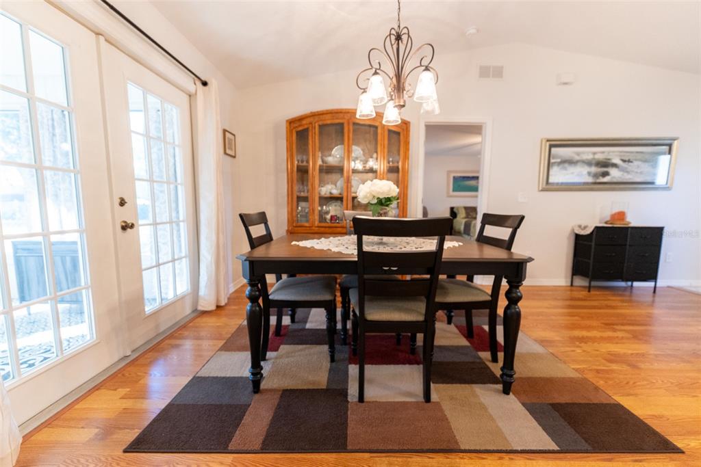 10470 Southwest 61st Terrace Road Ocala, FL 34476 - Photo 23 of 63 a view of a dining room with furniture window and wooden floor