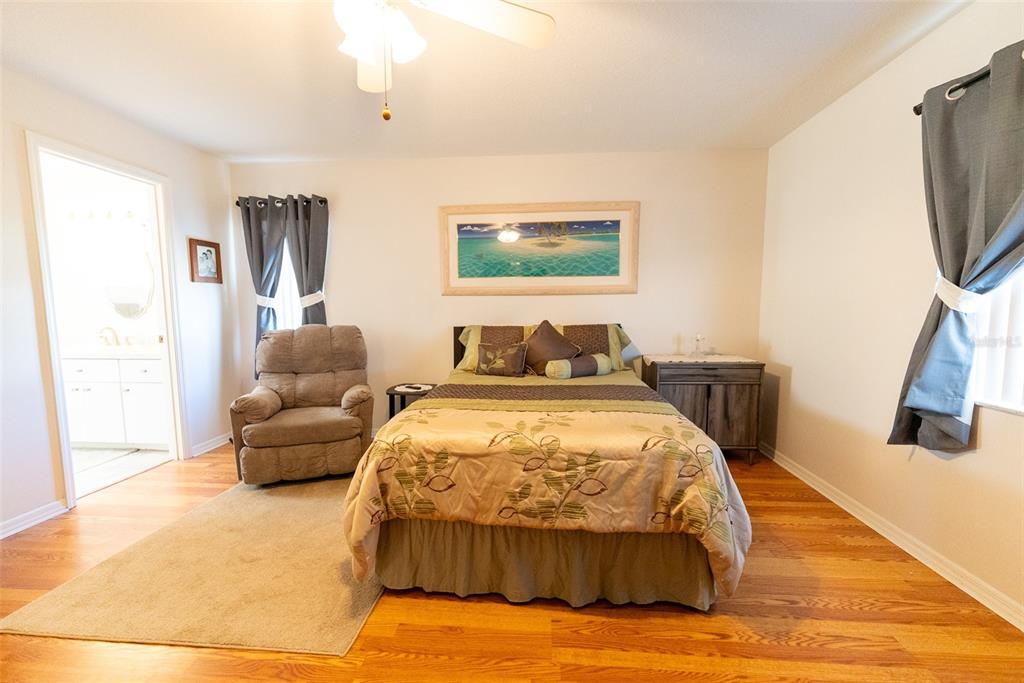 10470 Southwest 61st Terrace Road Ocala, FL 34476 - Photo 28 of 63 a bedroom with a bed and a flat screen tv