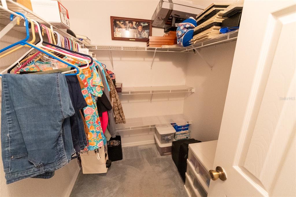 10470 Southwest 61st Terrace Road Ocala, FL 34476 - Photo 39 of 63 a view of walk in closet with clothes and shoes