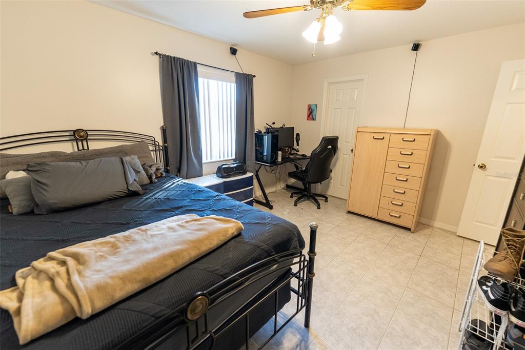 10470 Southwest 61st Terrace Road Ocala, FL 34476 - Photo 44 of 63 a living room with furniture and a flat screen tv