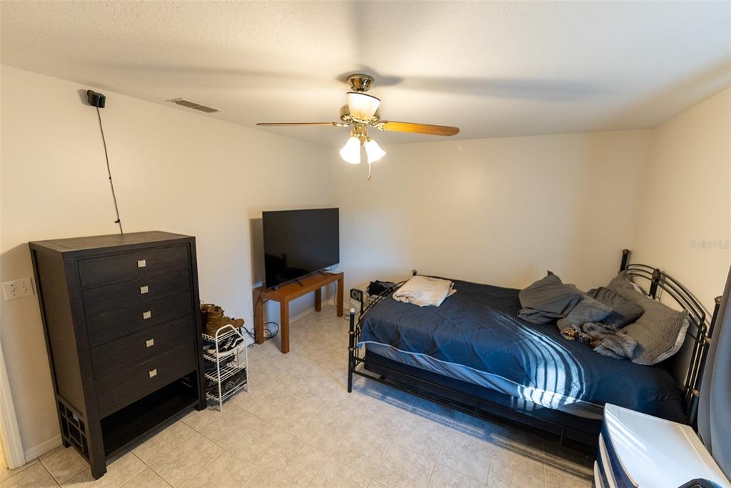 10470 Southwest 61st Terrace Road Ocala, FL 34476 - Photo 46 of 63 a living room with furniture and a flat screen tv