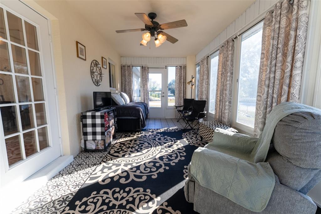 10470 Southwest 61st Terrace Road Ocala, FL 34476 - Photo 50 of 63 a living room with furniture a fireplace and a large window